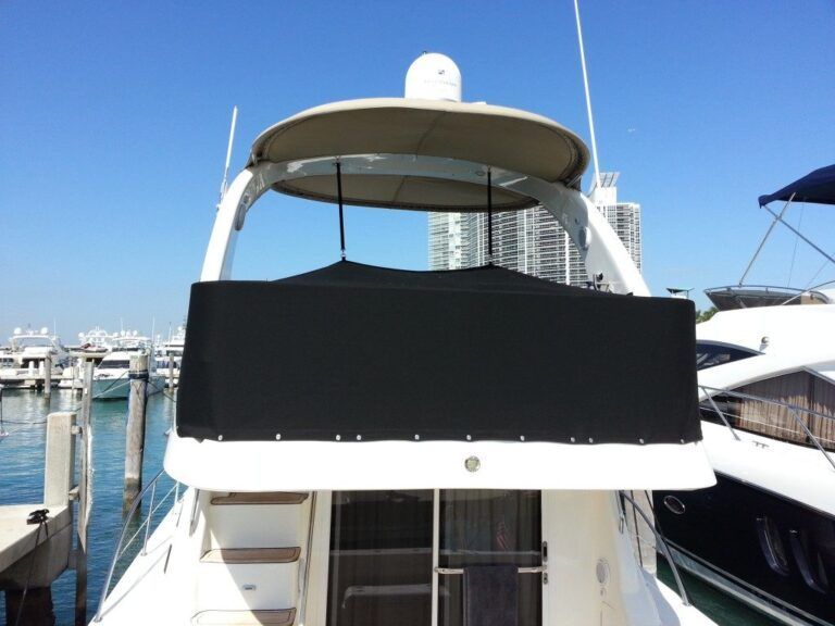 The front of a boat with a black cover on it