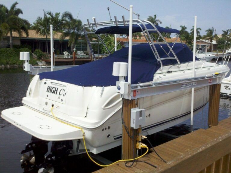 A white boat with the name high on the back