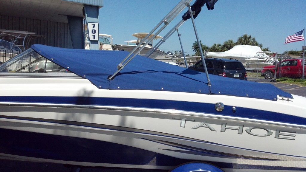 A white and blue boat with the word tahoe on the side