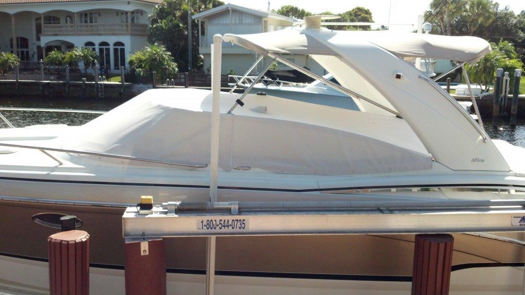 A white boat is docked at a dock with the number 1 on it
