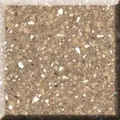 Close-up of a tan speckled stone or terrazzo surface with a dark border