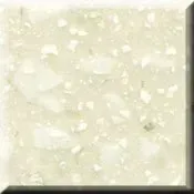 Close-up of a pale cream speckled tile or stone surface with a beveled edge