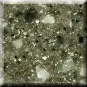 Close-up of a speckled green-gray stone or terrazzo surface with white and black flecks