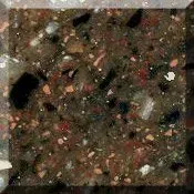 Close-up of speckled dark stone or concrete with pink, white, and black flecks