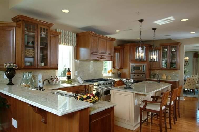 Spacious modern kitchen with wood cabinets, white island, and hardwood floors