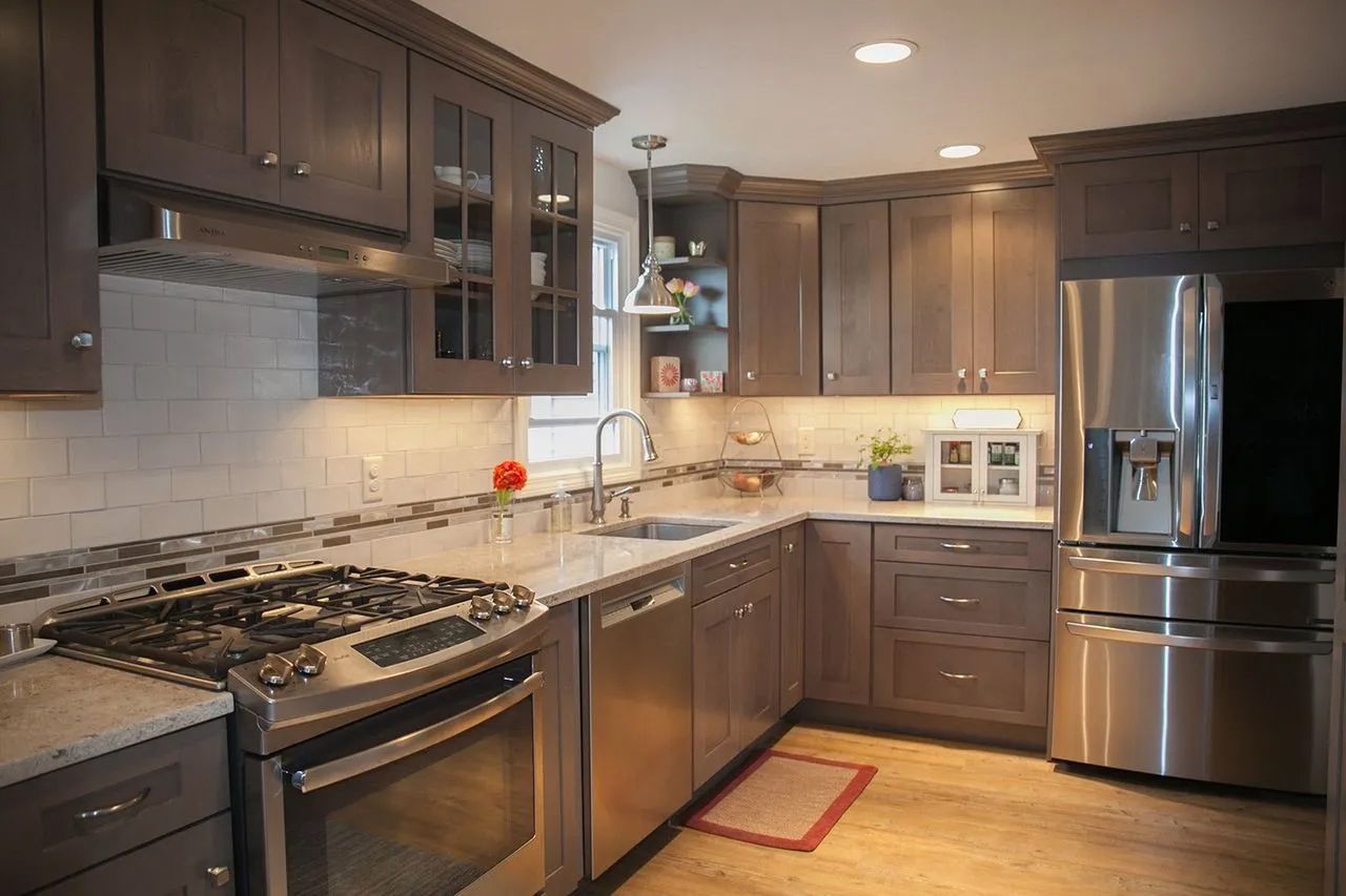 A kitchen with stainless steel appliances and gray cabinets