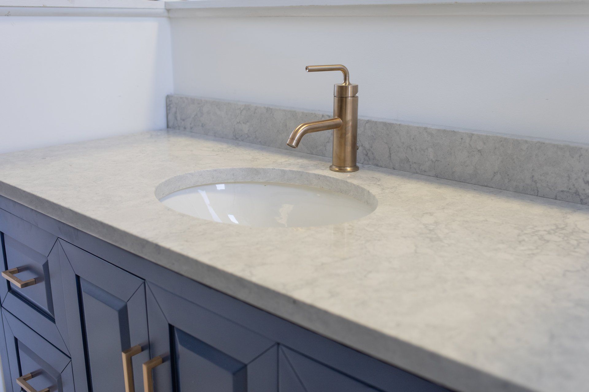 A bathroom vanity with a sink and a faucet.