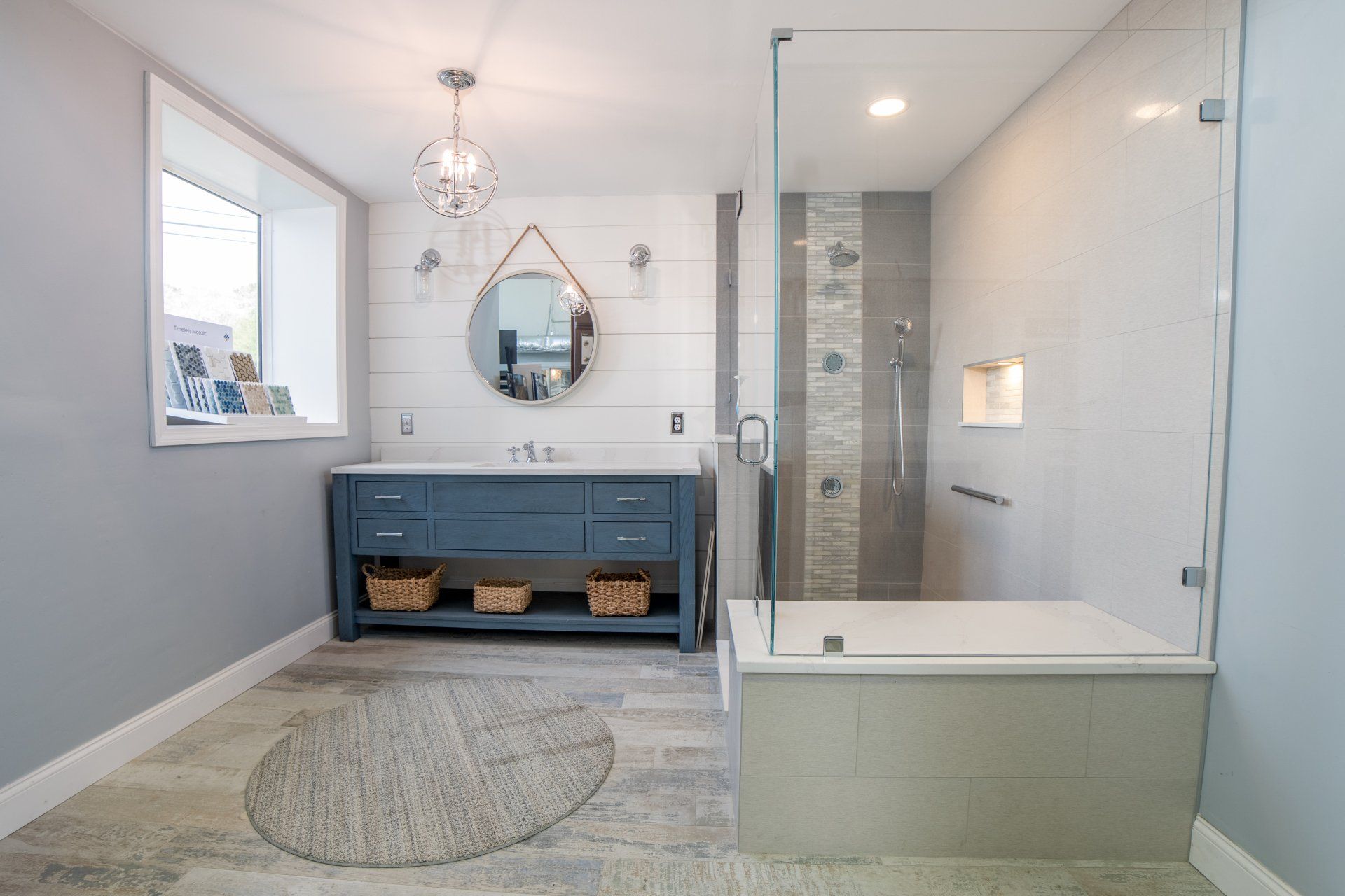 A bathroom with a tub , sink , mirror and shower.