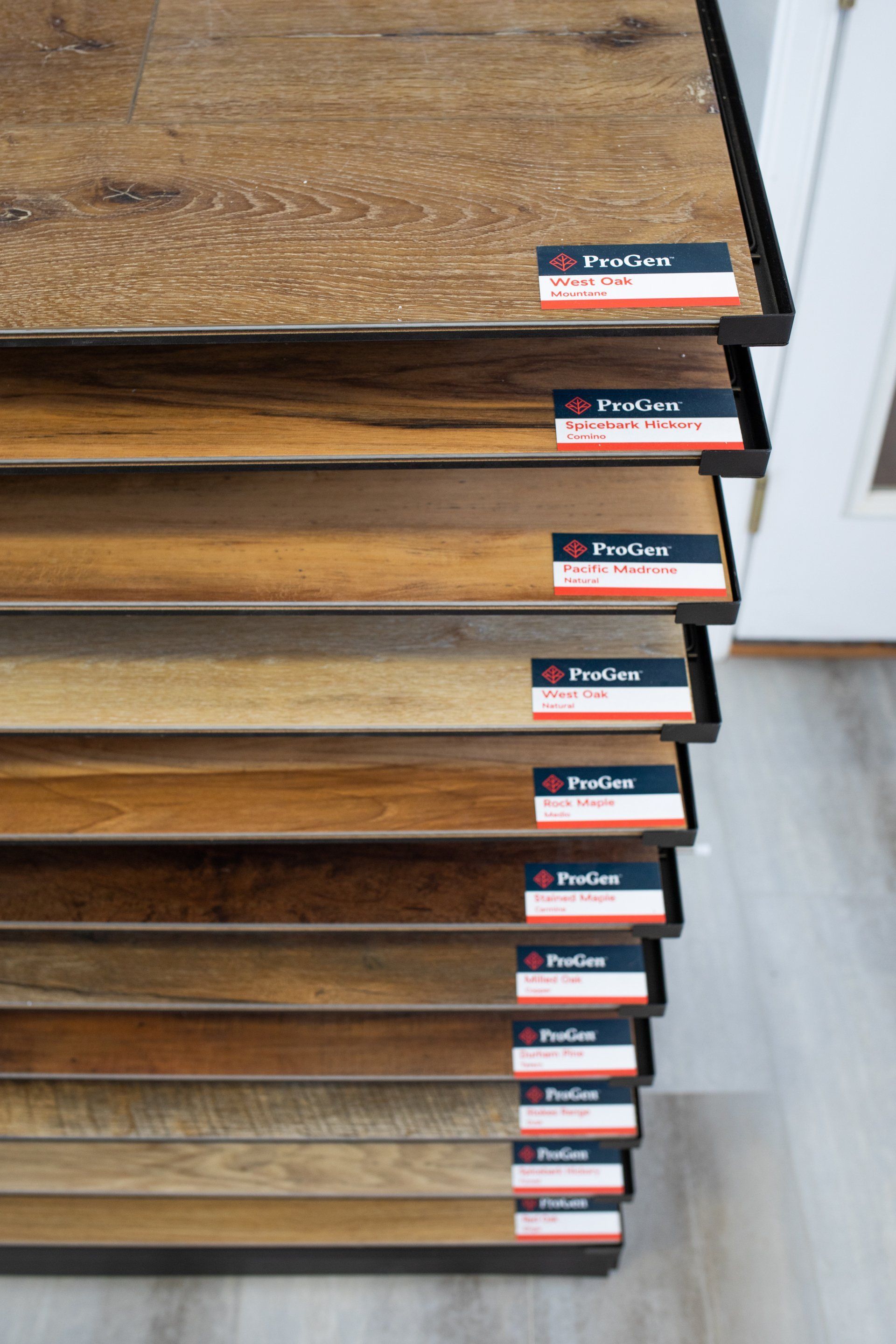 A stack of wooden flooring samples in a store.