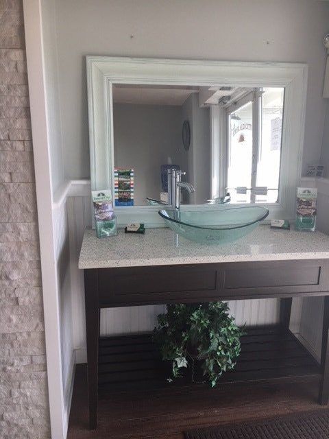 A bathroom vanity with a sink and a mirror.