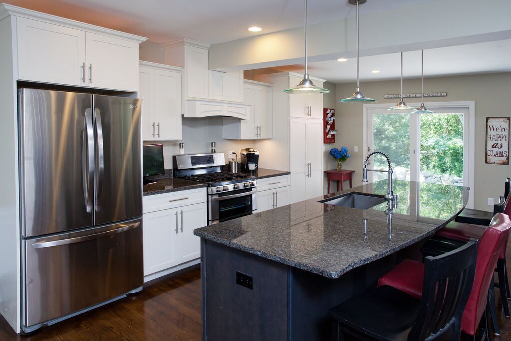 A kitchen with stainless steel appliances and granite counter tops.