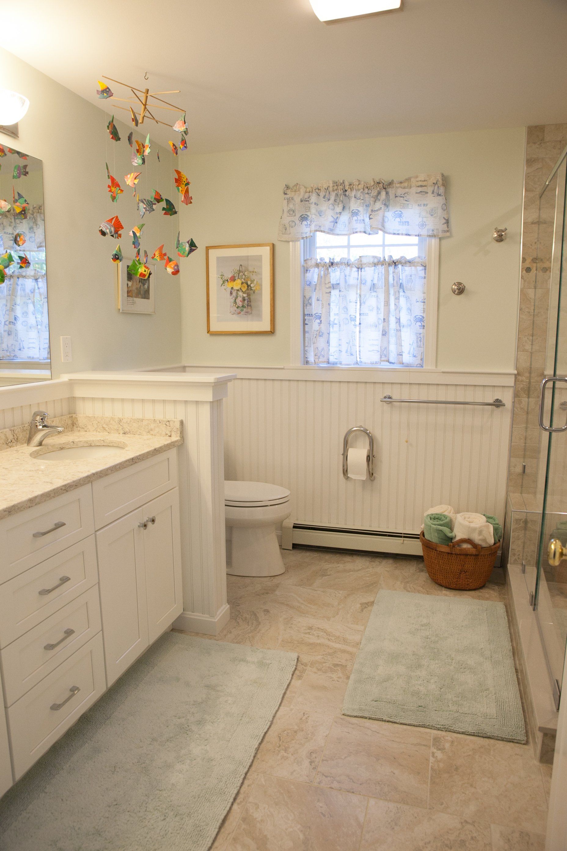 A bathroom with a toilet , sink , and mirror.