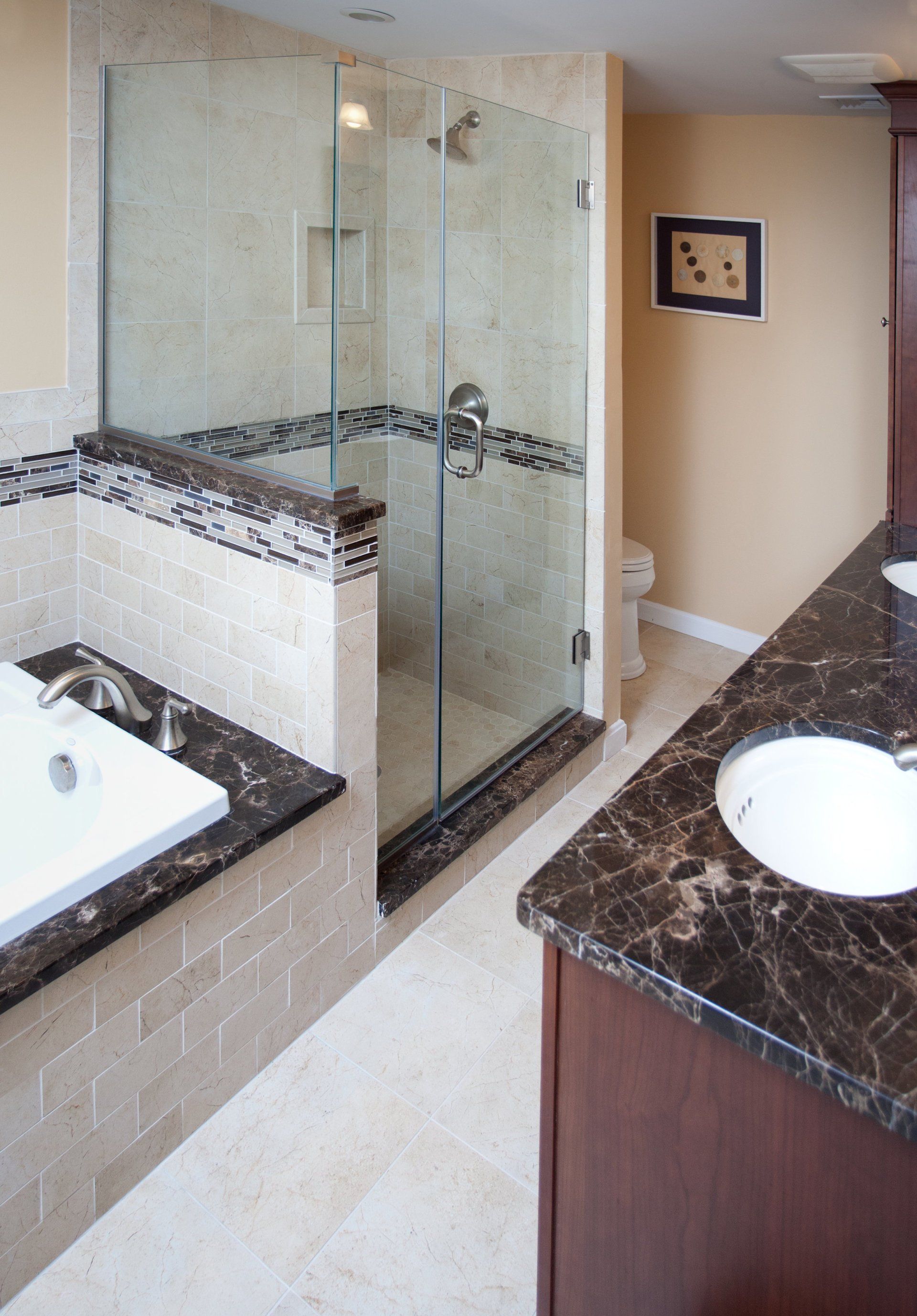 A bathroom with a tub a sink and a walk in shower