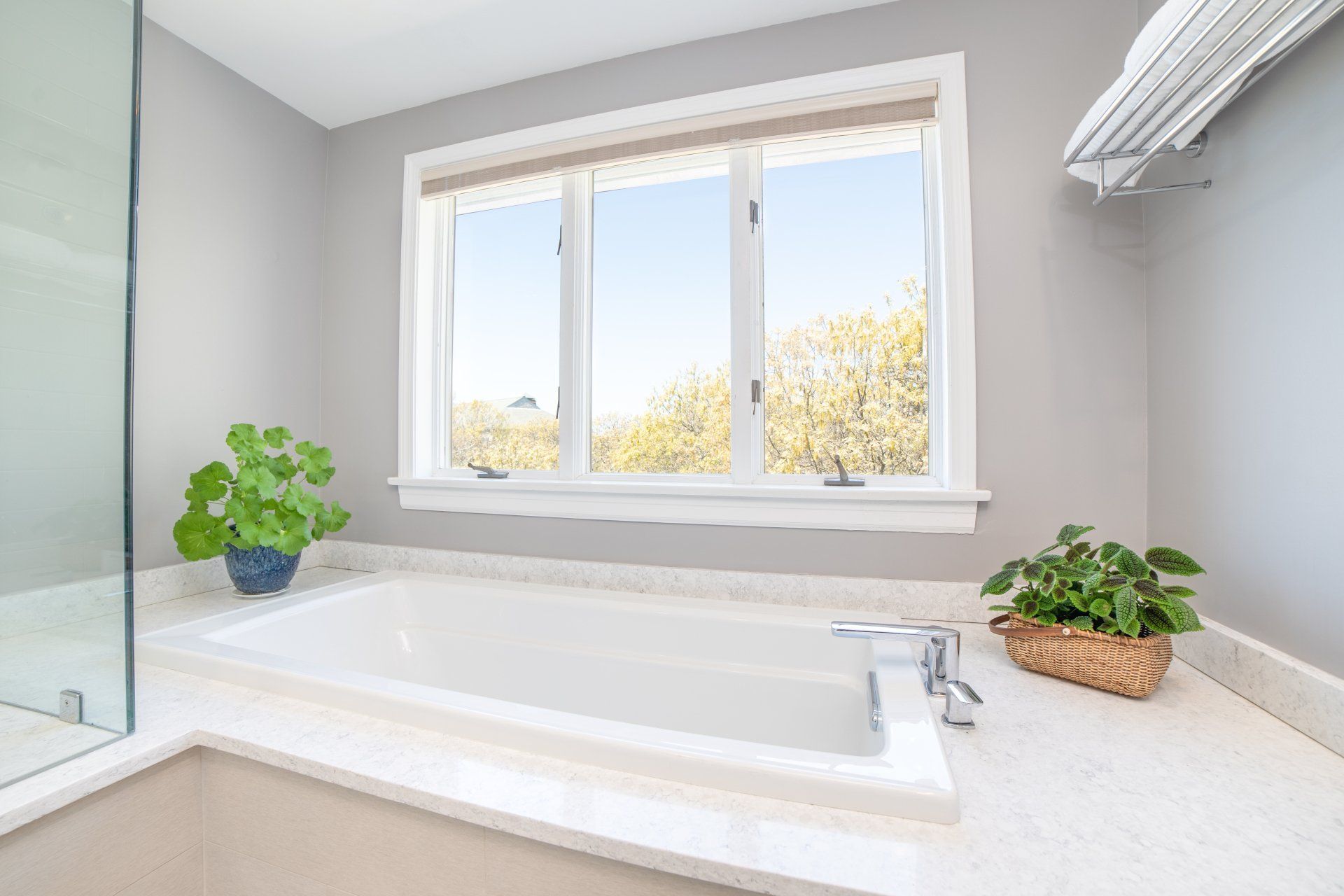 A bathroom with a bathtub and a window.