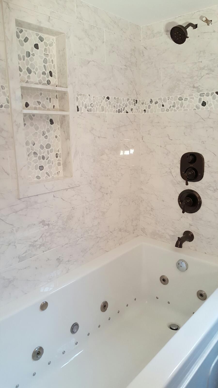 A bathroom with a jacuzzi tub and a shower.