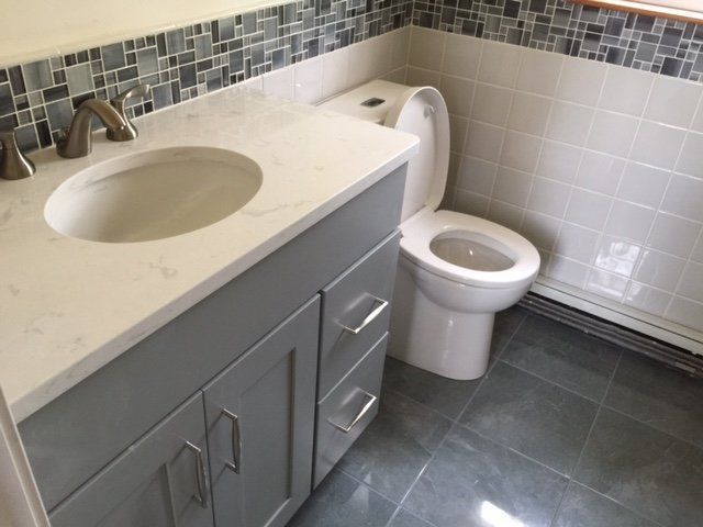 A bathroom with a sink and toilet in it