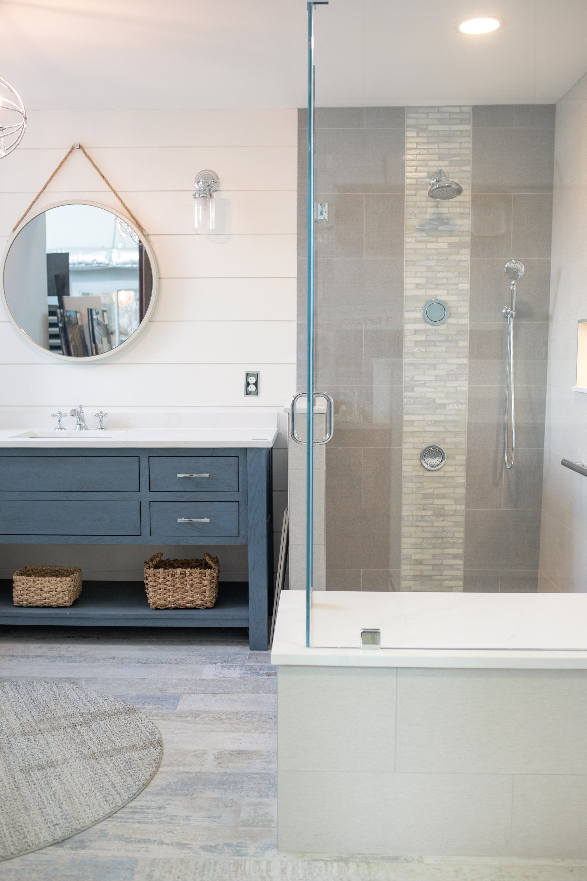 A bathroom with a walk in shower , sink , and mirror.