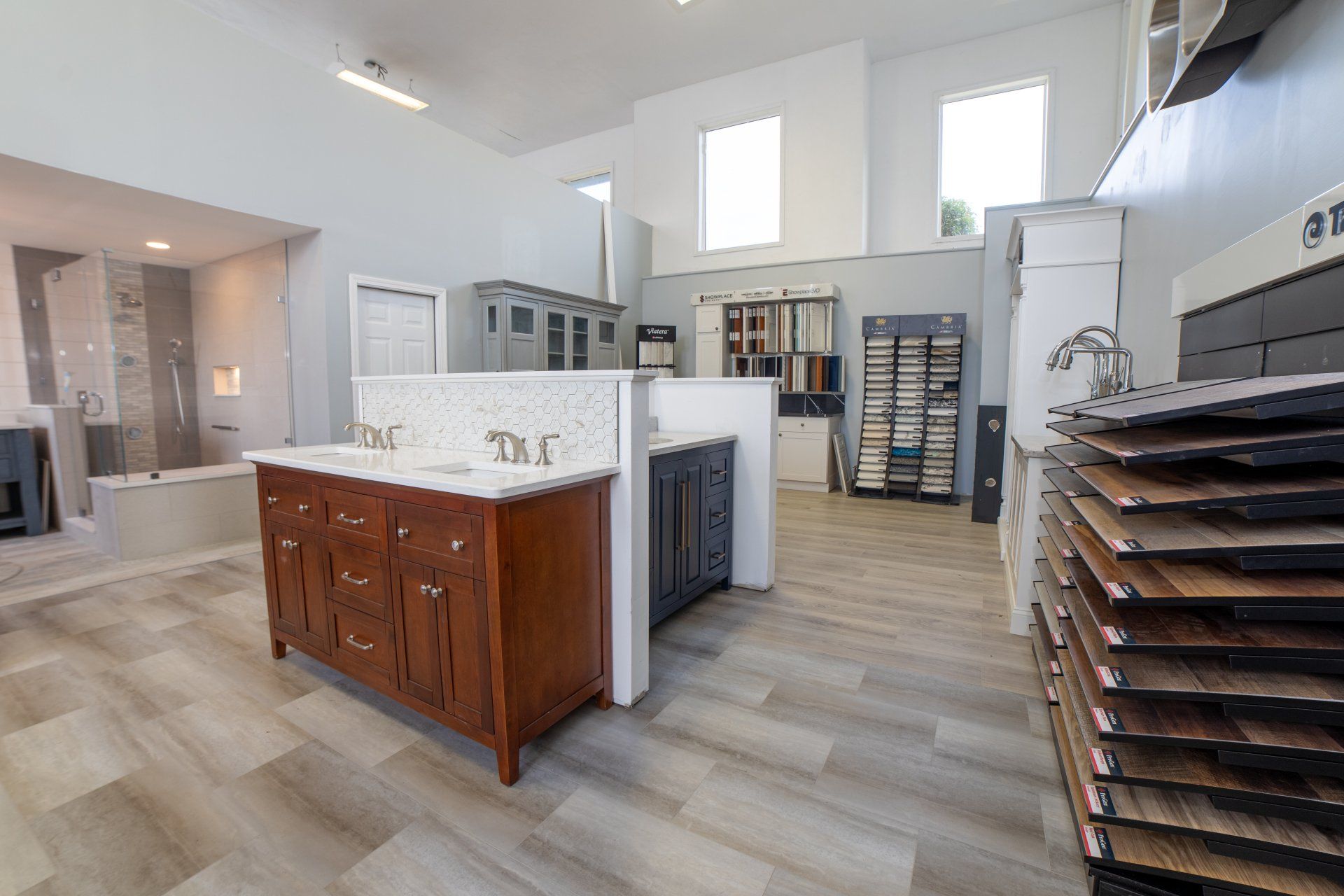 A bathroom showroom with a sink and a stack of hardwood flooring.