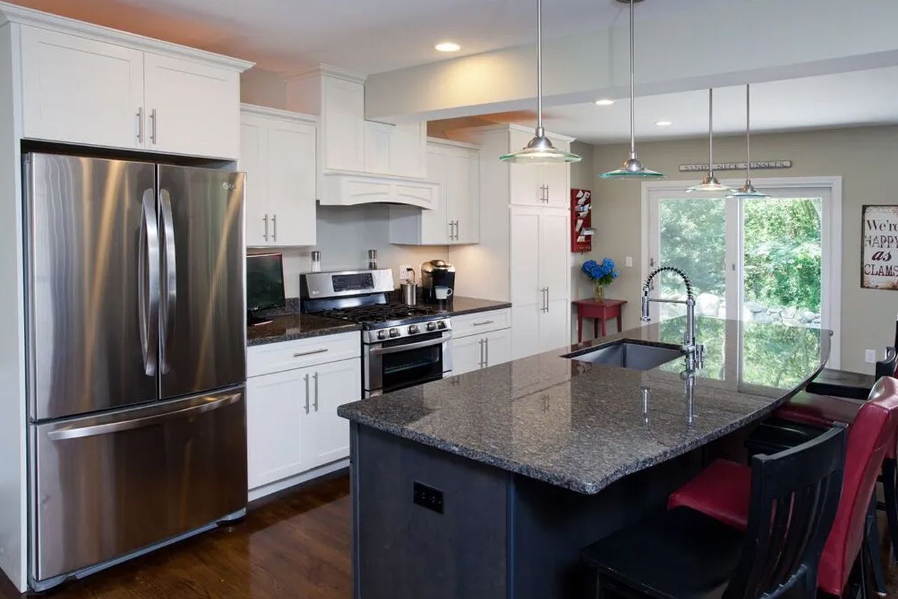 A kitchen with stainless steel appliances and granite counter tops