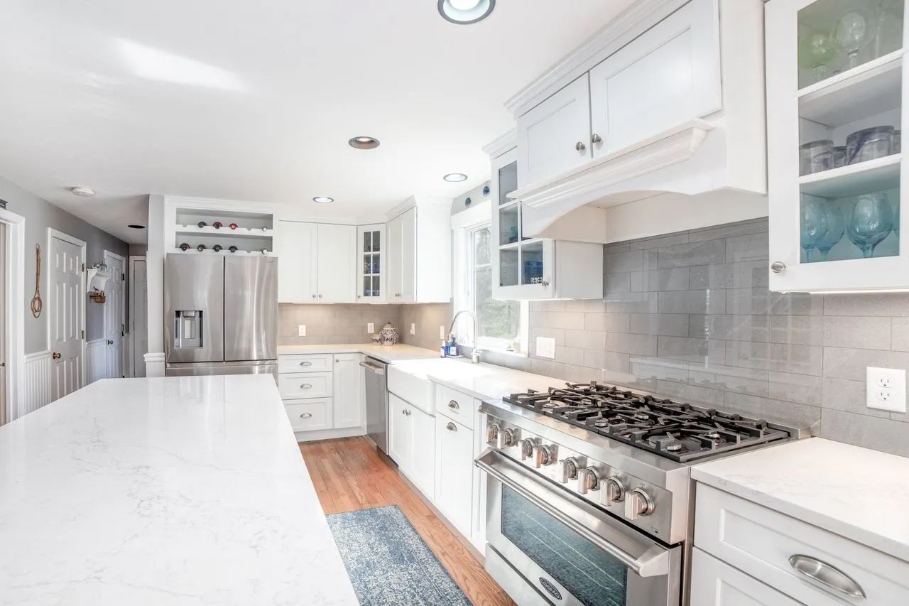 A kitchen with white cabinets and stainless steel appliances
