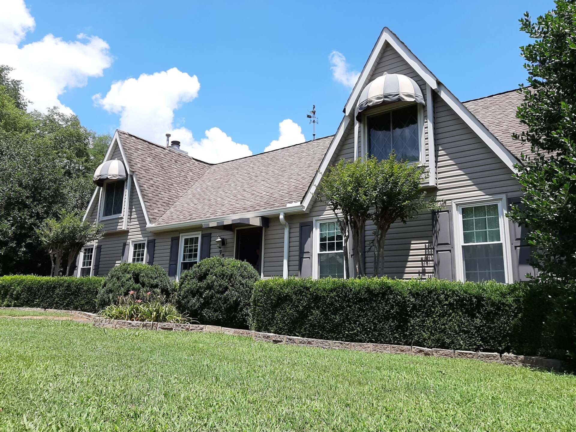 A large house with a roof that has a canopy on it