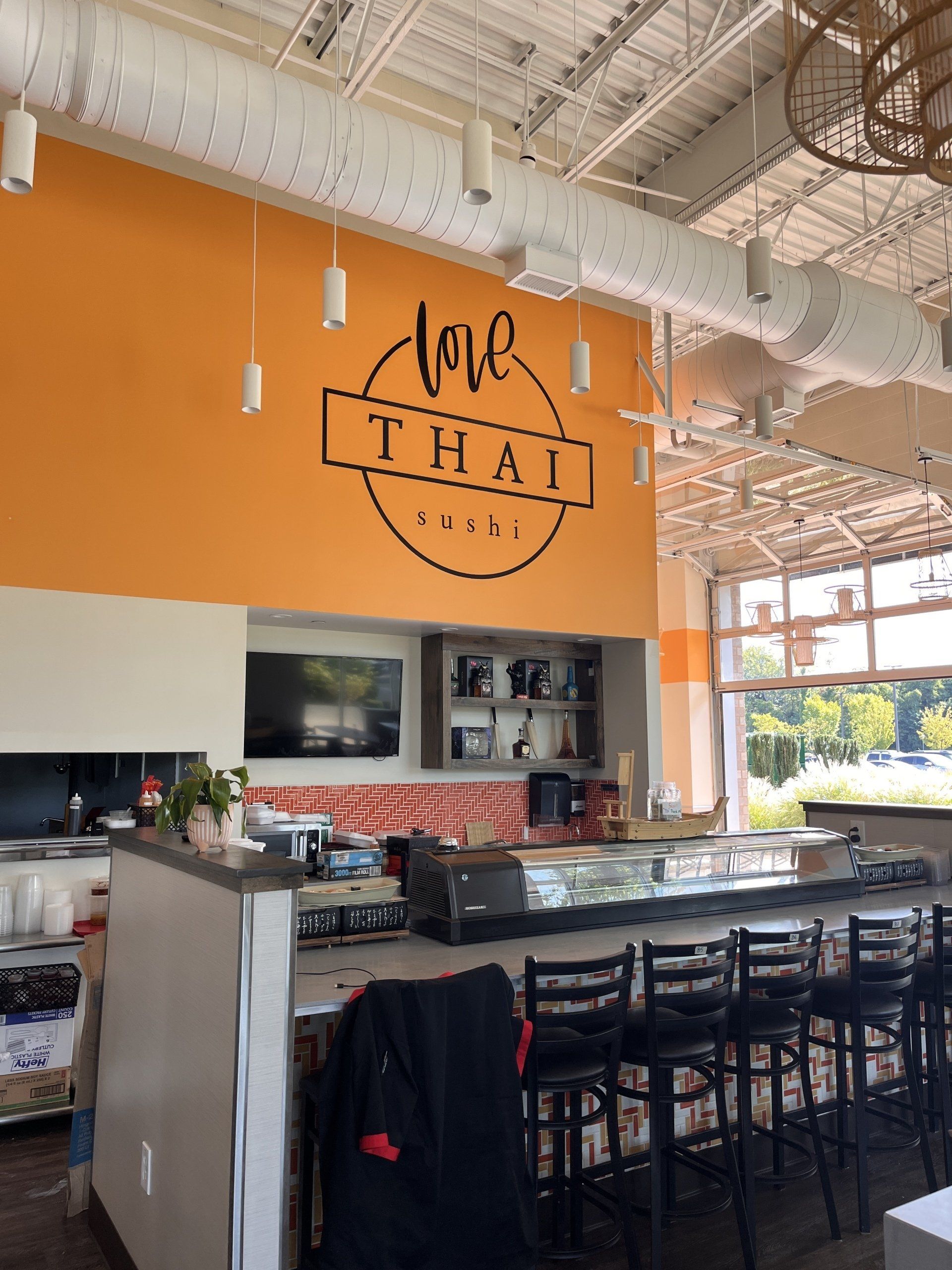 A restaurant with a sign that says love thai