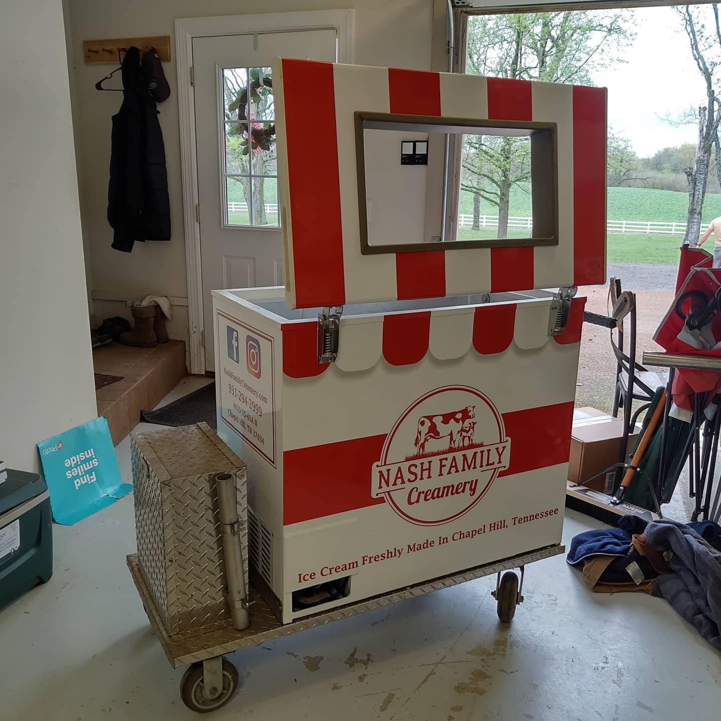 A red and white nash family country ice chest on wheels