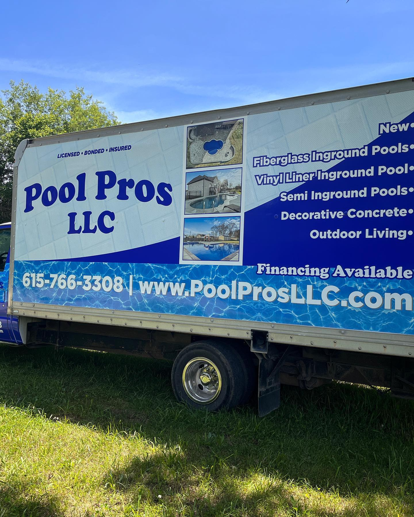 A pool pros llc truck is parked in the grass.