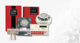 Fire alarm system components, including red control panels, smoke detectors, and a siren