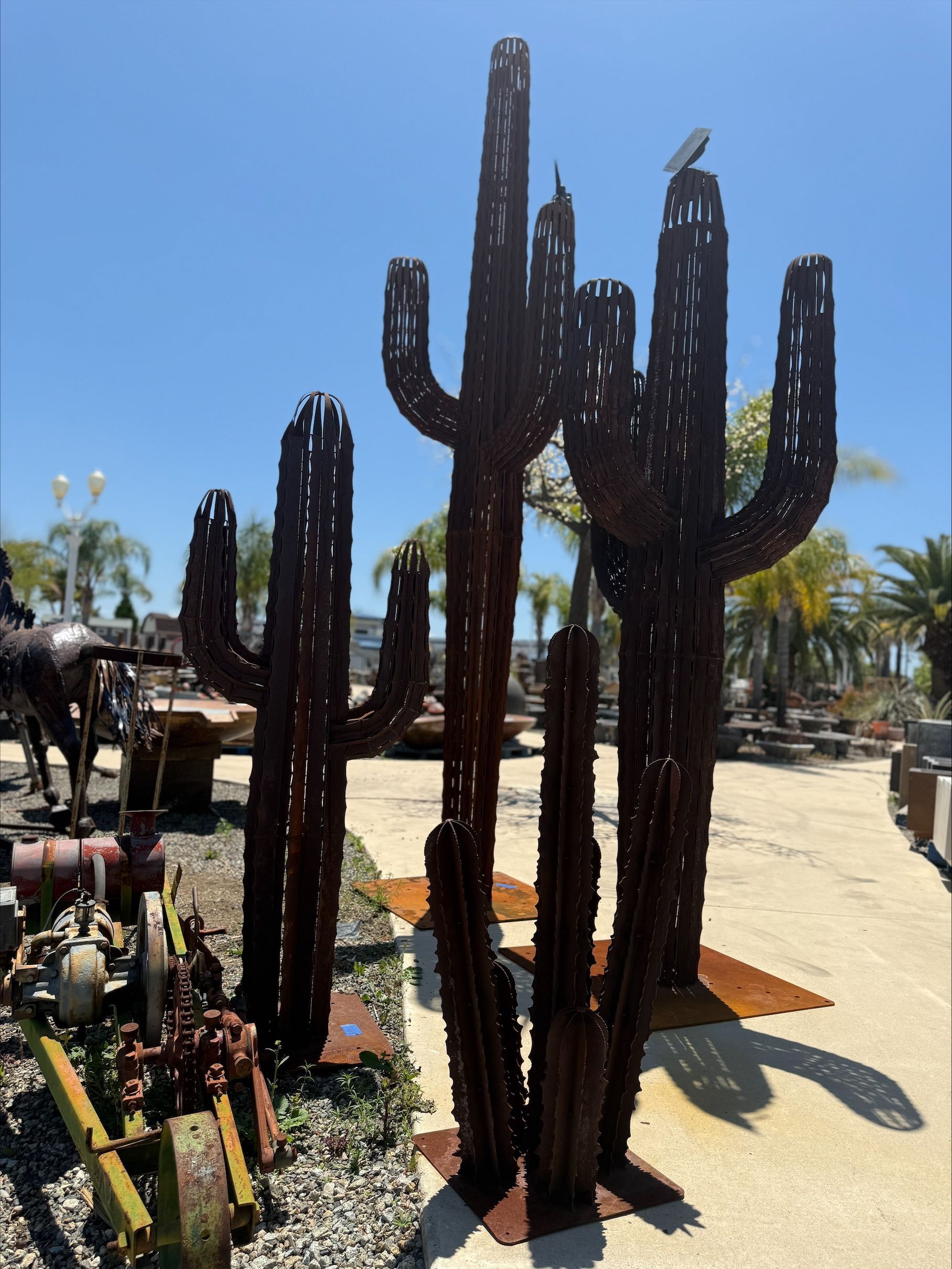 A statue of a cactus with a bird on top of it