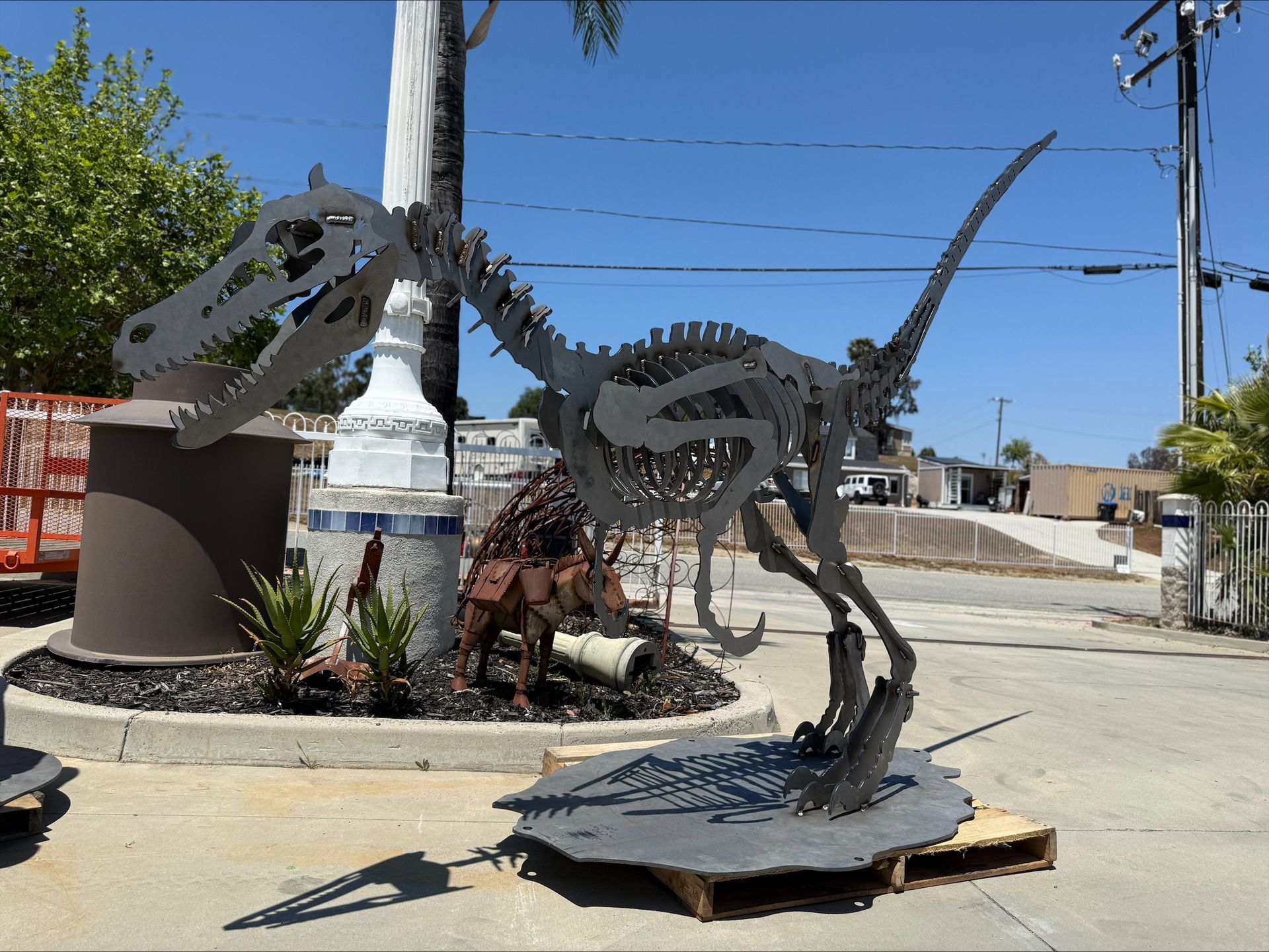 A statue of a dinosaur is sitting on a pallet