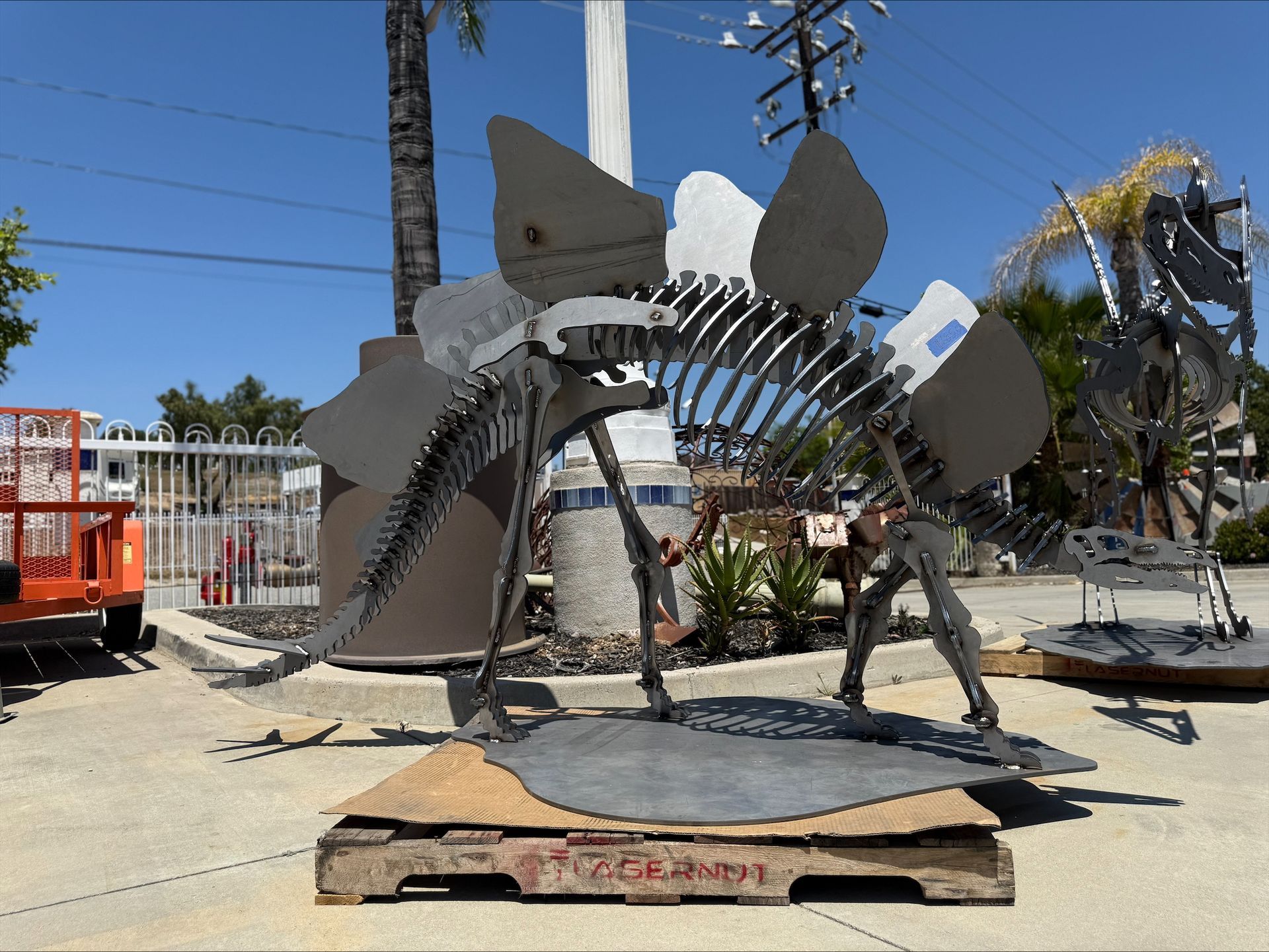 A statue of a dinosaur is sitting on a wooden pallet