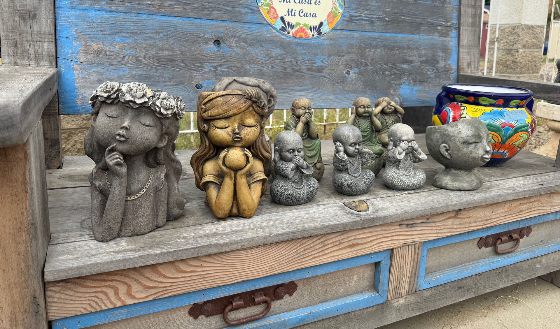 A bunch of statues are sitting on top of a wooden table.