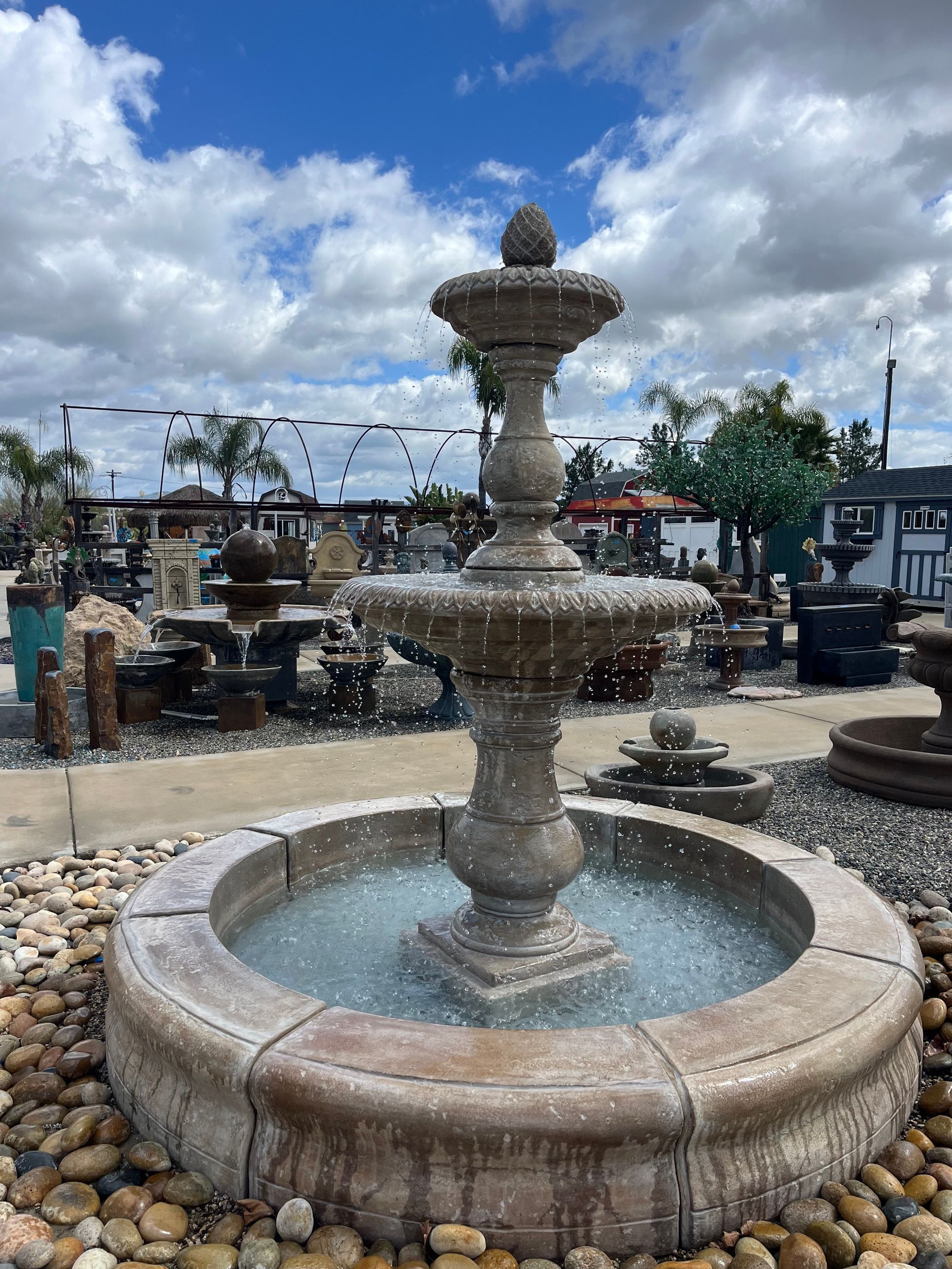 A large fountain is sitting on top of a pile of rocks.