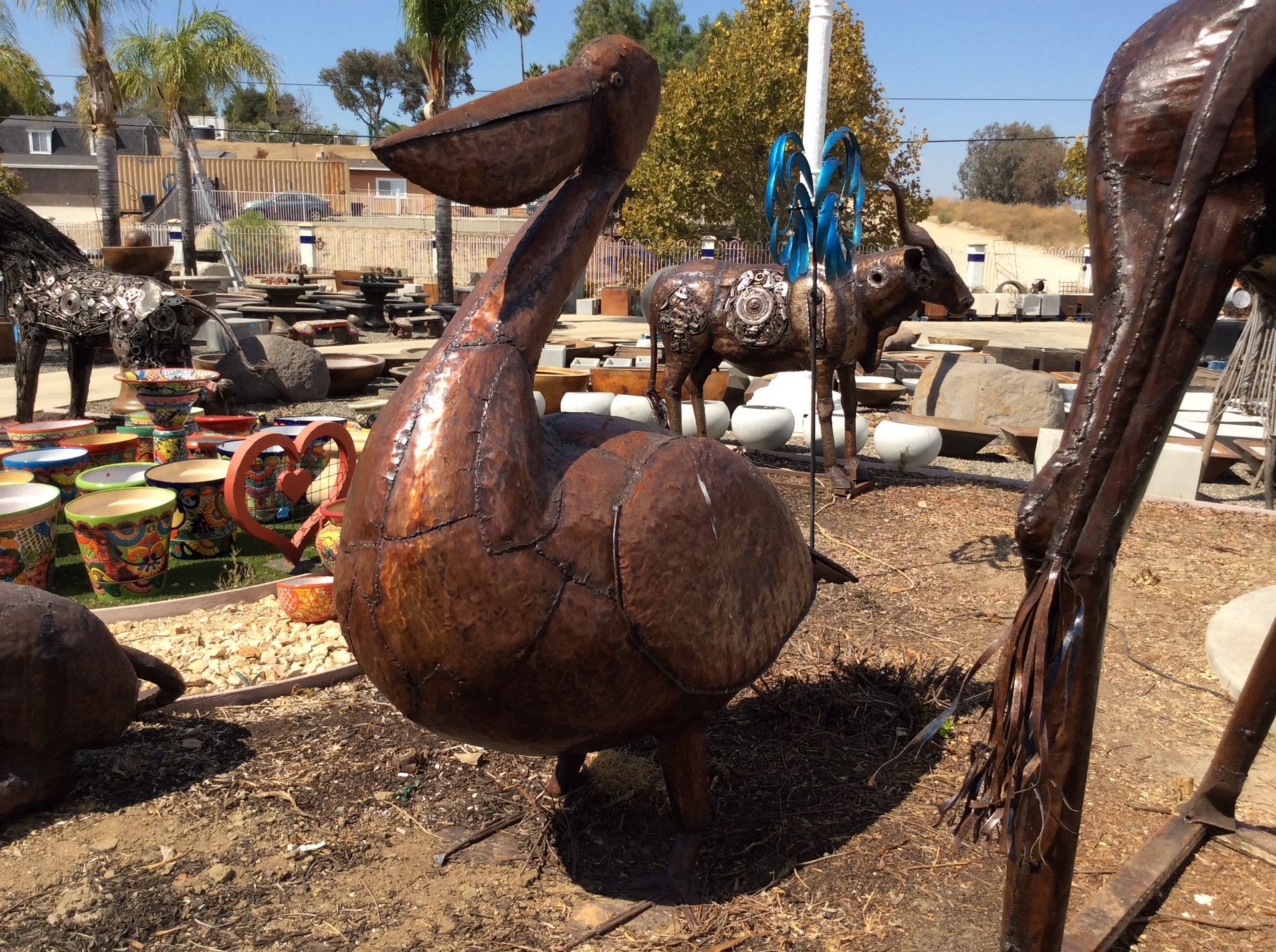 A statue of a pelican is standing in the dirt