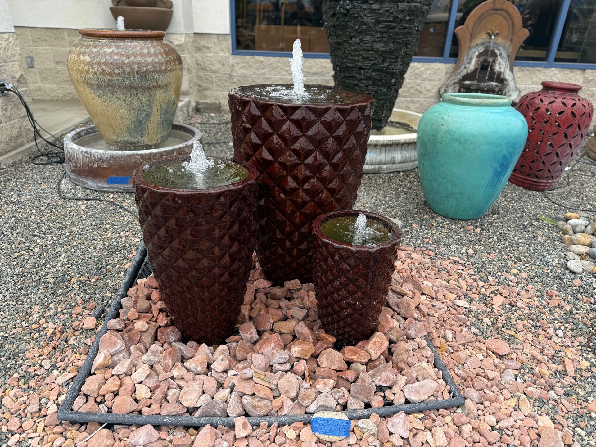 A fountain is sitting on top of a pile of rocks.