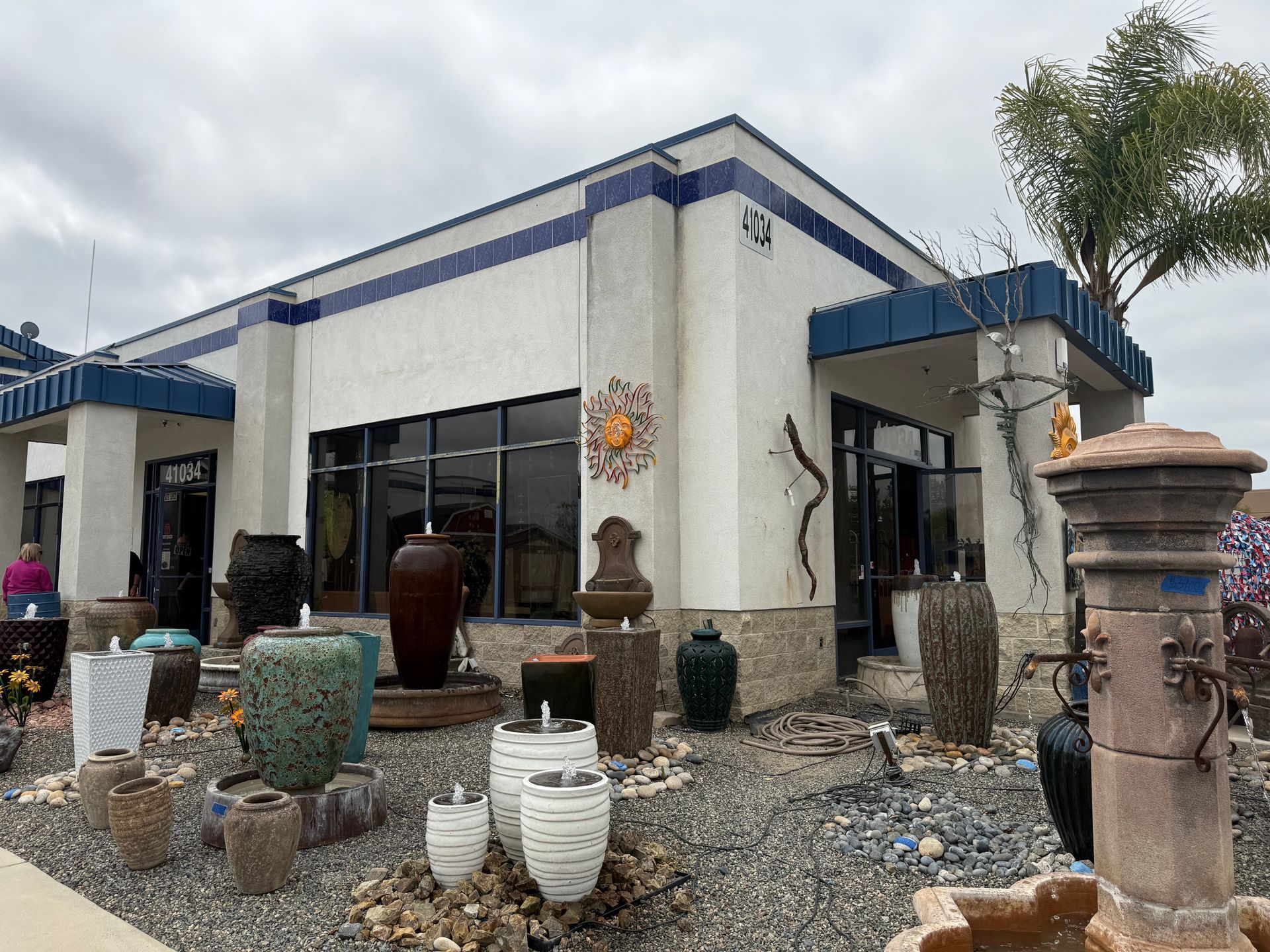 A building with a lot of pots in front of it