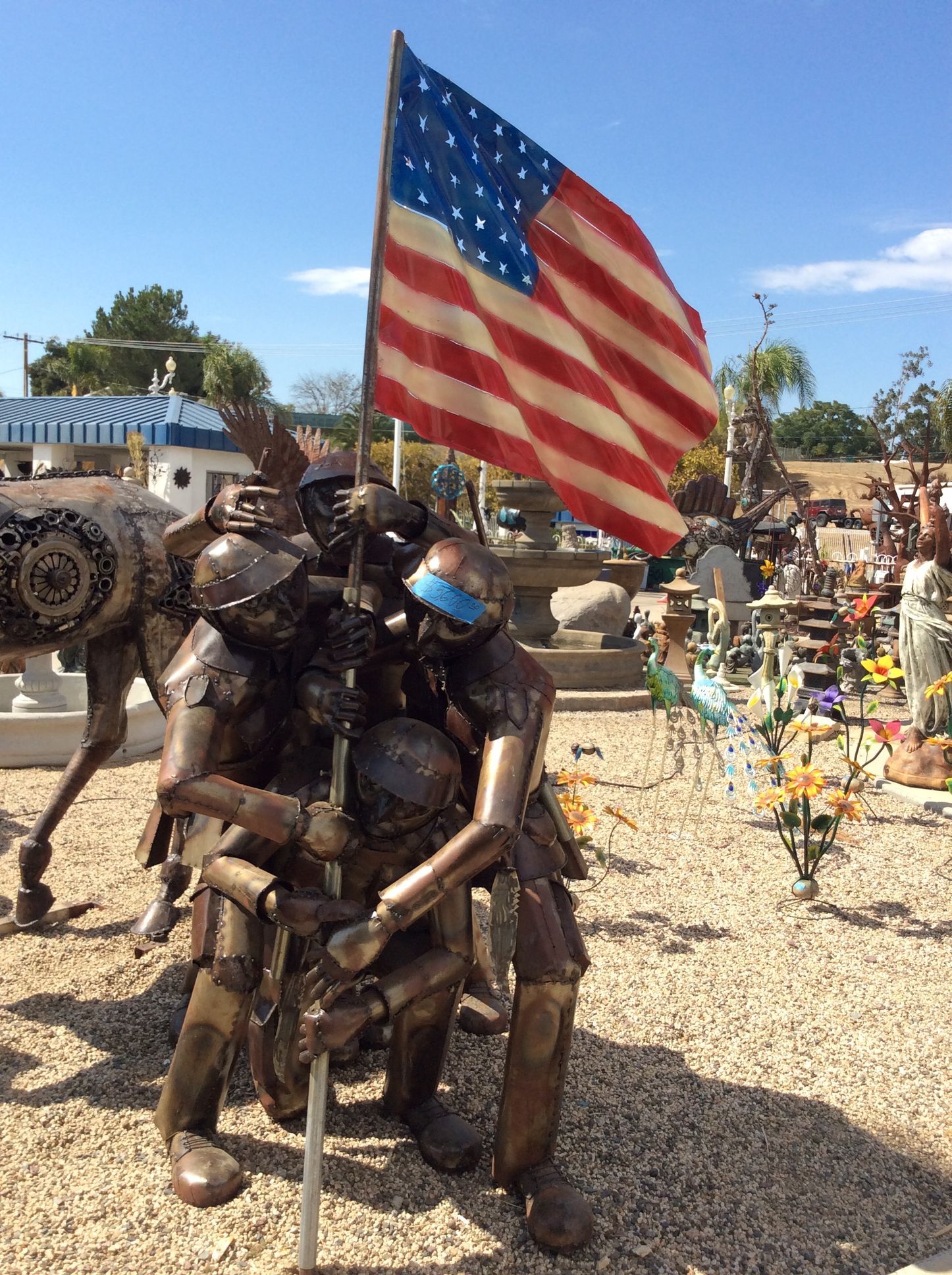 A statue of a man holding an american flag