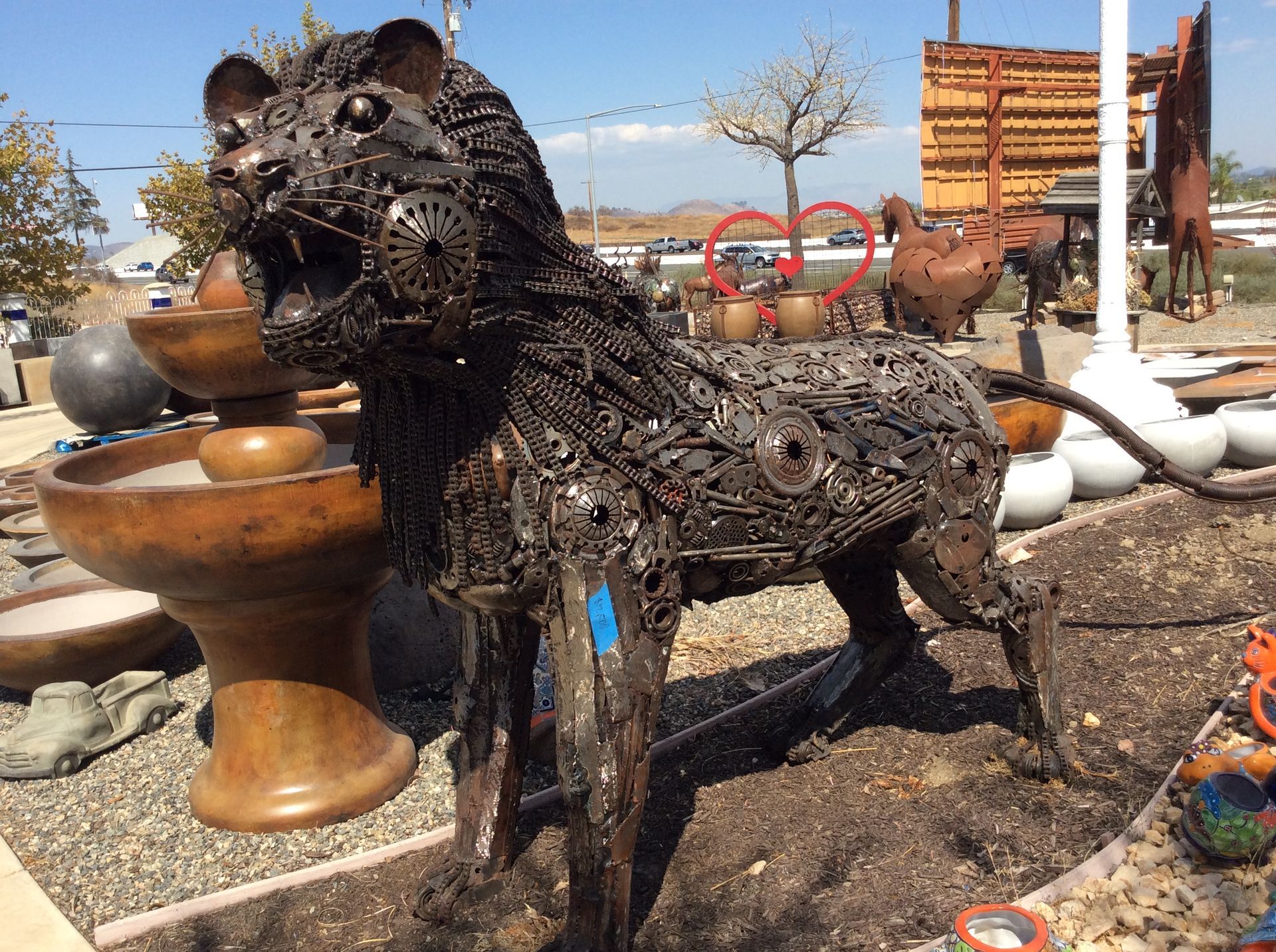 A metal statue of a lion with its mouth open