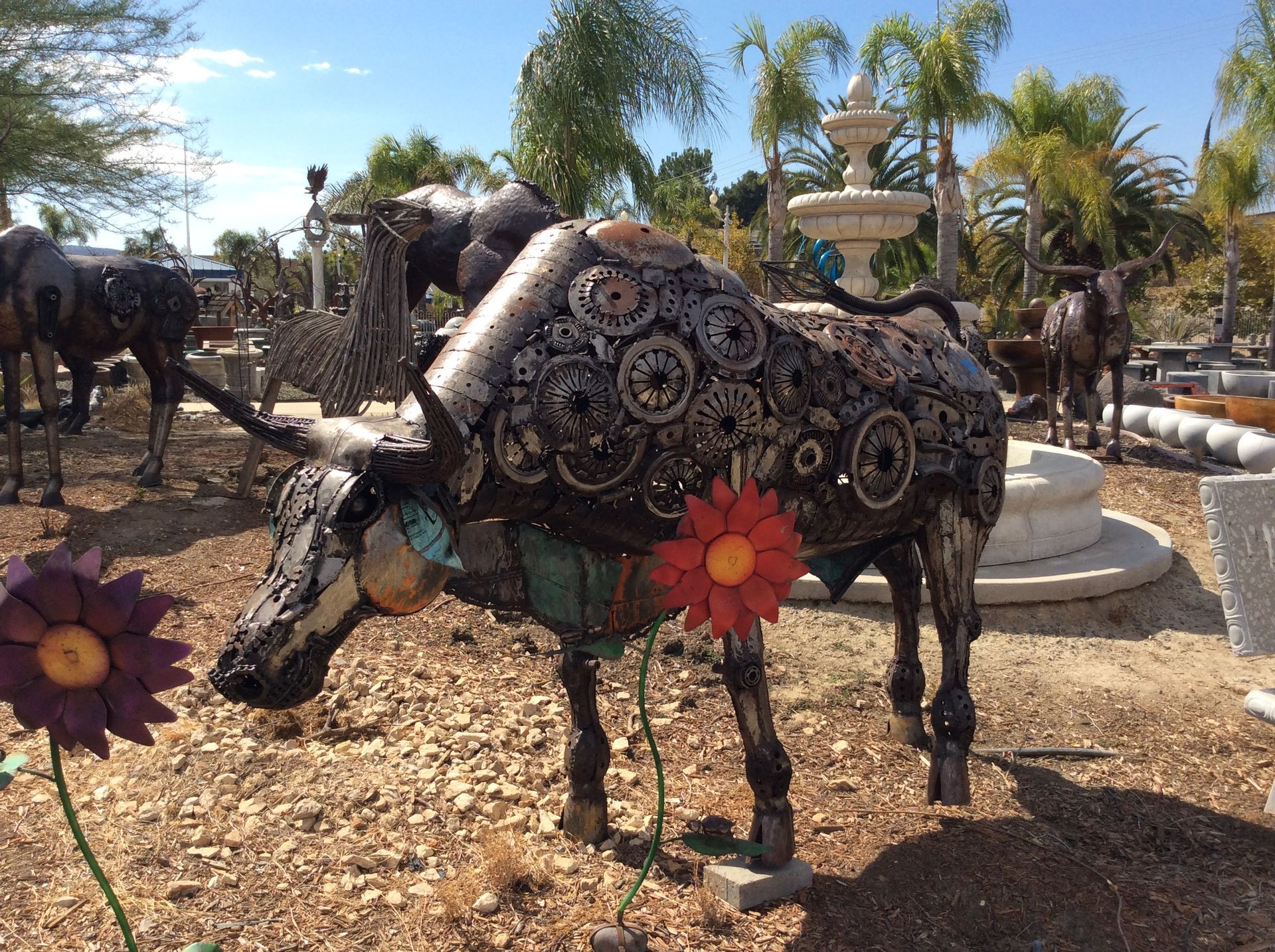 A statue of a bull with a flower in its mouth
