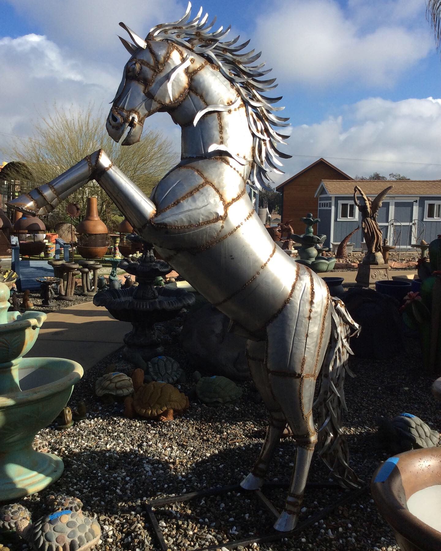 A metal statue of a unicorn standing on its hind legs