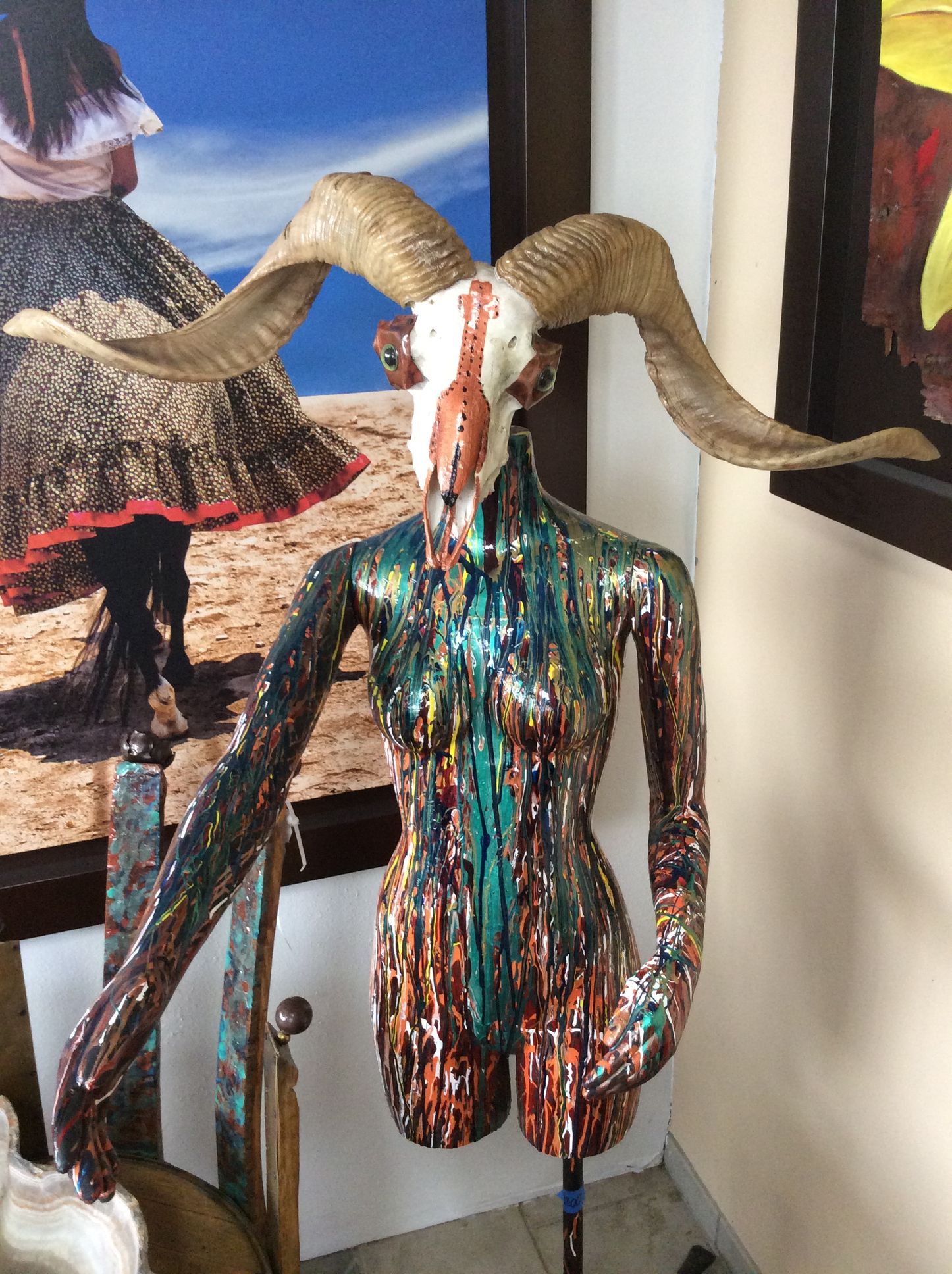 A mannequin with a goat skull on top of it