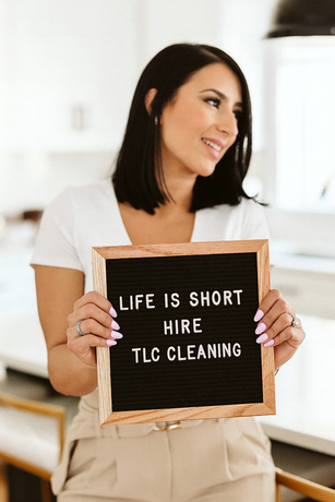 A woman is holding a sign that says