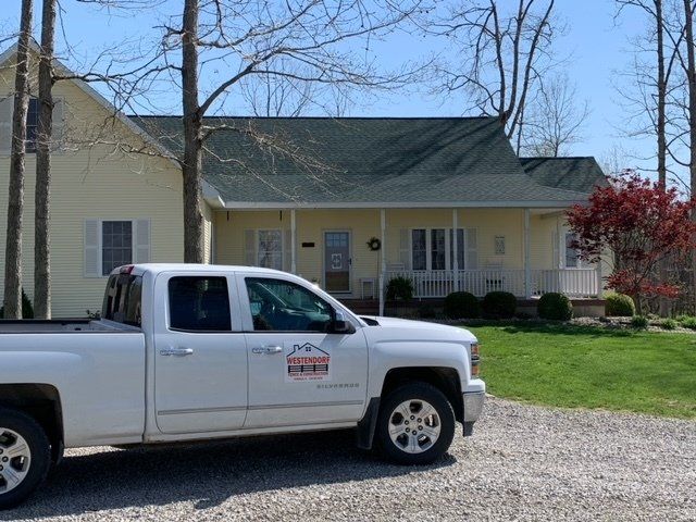 Pickup Truck in front of a house with green roof