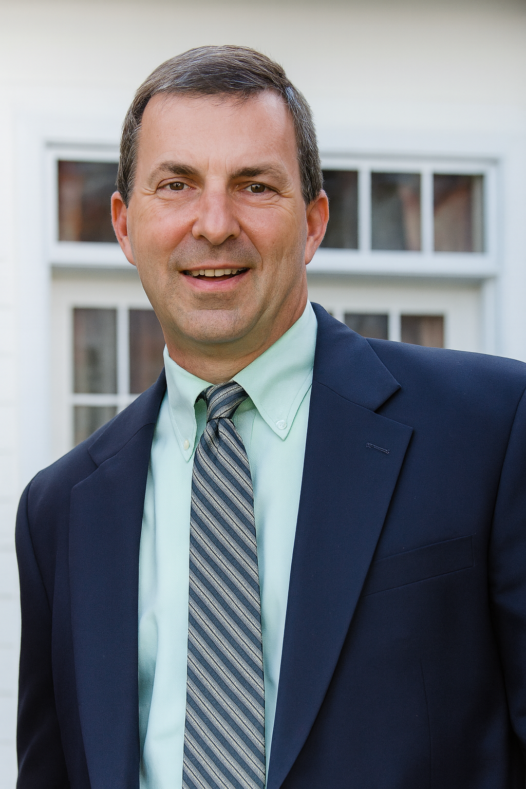 Silhouette of a person against a gray background, showing the head, shoulders, and upper torso.