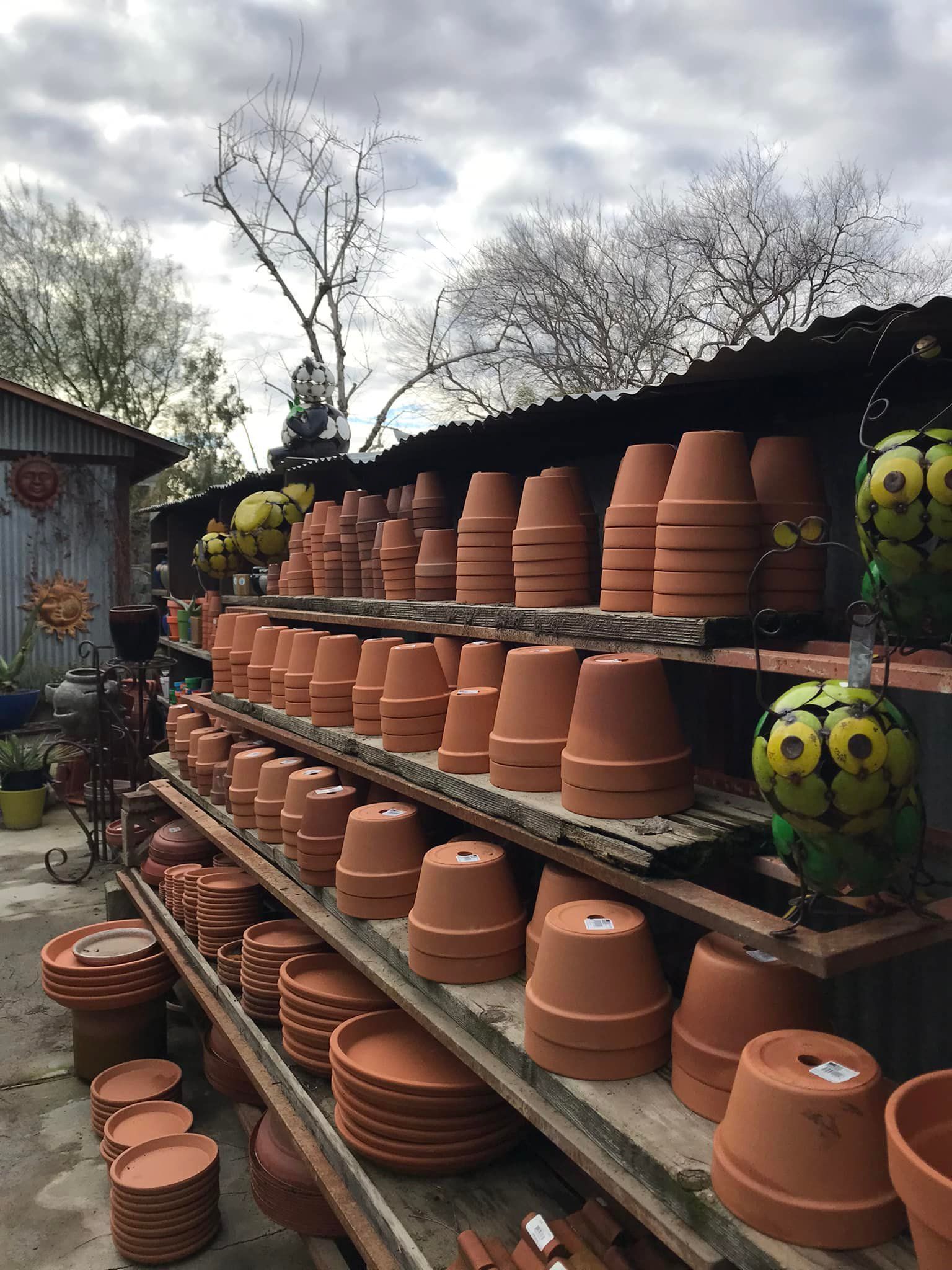 A shelf filled with lots of clay pots and plates.