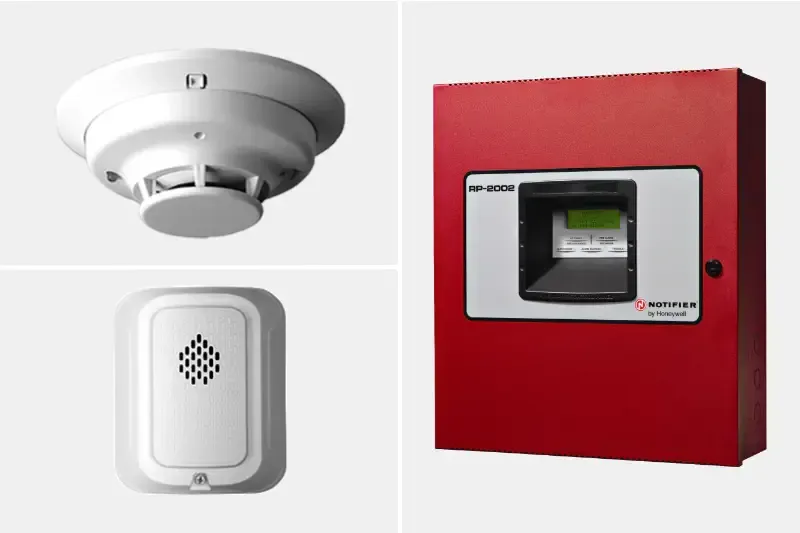 Fire safety equipment: smoke detector, alarm, and red fire panel.