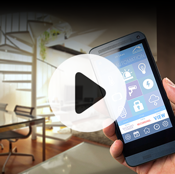 A person holds a smartphone displaying a home automation app with a modern living room in the background.