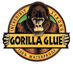 A gorilla is holding a sign that says gorilla glue