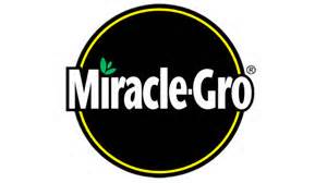 The logo for miracle gro is a black circle with a yellow border.